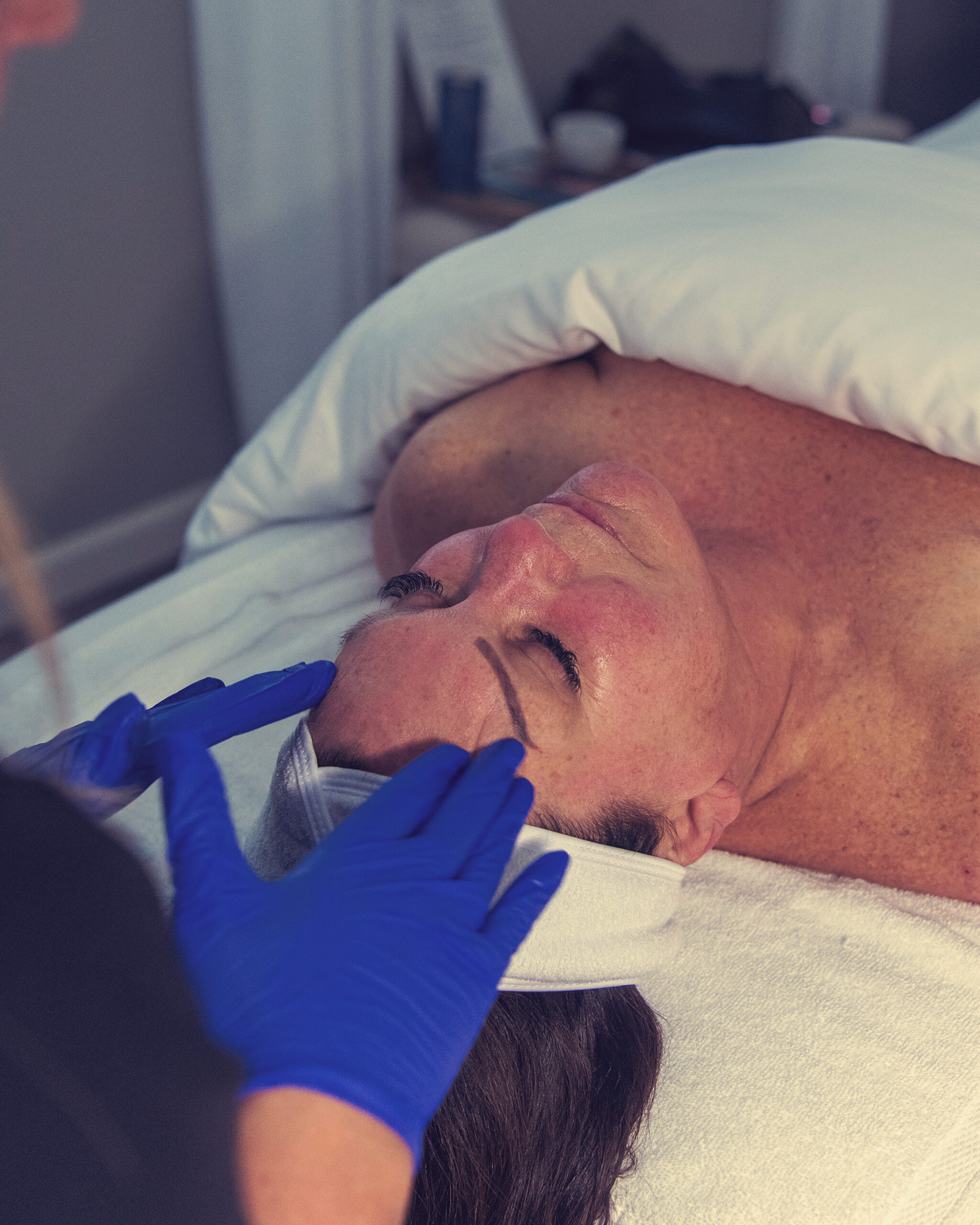 Clarifying facial with blue mask treatment at Adorne Medical Aesthetics during holiday season.
